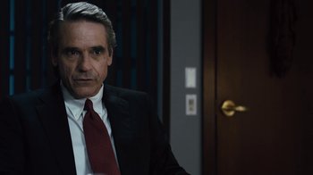 Movie still from “Margin Call” (2011), directed by J.C. Chandor – A man in a suit and a red tie; Close Up shot, Over the shoulder angle