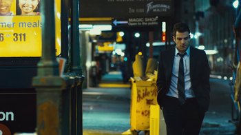 Movie still from “Margin Call” (2011), directed by J.C. Chandor – A man walking down a street at night; Medium shot, Over the shoulder angle