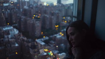 Movie still from “Margin Call” (2011), directed by J.C. Chandor – A woman looking out of a window at night; Close Up shot, High angle