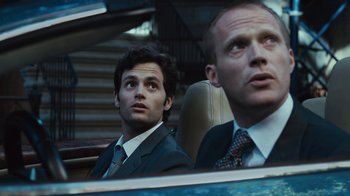 Movie still from “Margin Call” (2011), directed by J.C. Chandor – Two men in suits sitting in the back of a car; Close Up shot, Low angle