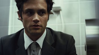 Movie still from “Margin Call” (2011), directed by J.C. Chandor – A person wearing a suit and tie; Close Up shot, Over the shoulder angle