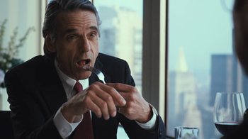 Movie still from “Margin Call” (2011), directed by J.C. Chandor – A person wearing a suit and tie; Close Up shot, Over the shoulder angle