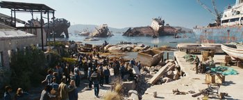 Movie still from “Maze Runner: The Death Cure” (2018), directed by Wes Ball – A group of people standing on top of a beach next to the ocean; Extreme Wide shot, High angle