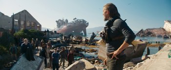 Movie still from “Maze Runner: The Death Cure” (2018), directed by Wes Ball – A group of people standing on top of a beach near a ship; Wide shot, Over the shoulder angle