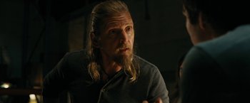 Movie still from “Maze Runner: The Death Cure” (2018), directed by Wes Ball – A man with long hair and a long beard; Close Up shot, Over the shoulder angle