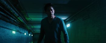 Movie still from “Maze Runner: The Death Cure” (2018), directed by Wes Ball – A man standing in a dark room with a green light; Medium shot, Low angle