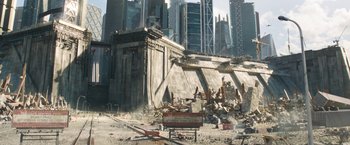 Movie still from “Maze Runner: The Death Cure” (2018), directed by Wes Ball – A building that has been demolished in the middle of a city; Extreme Wide shot, High angle