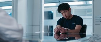 Movie still from “Maze Runner: The Death Cure” (2018), directed by Wes Ball – A man sitting at a table with handcuffs on his hands; Medium shot, Low angle