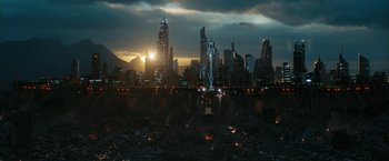 Movie still from “Maze Runner: The Death Cure” (2018), directed by Wes Ball – A view of a city skyline at night with the sun setting in the background; Extreme Wide shot, High angle