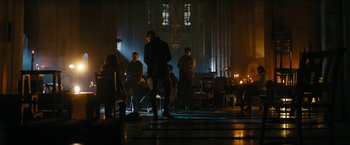 Movie still from “Maze Runner: The Death Cure” (2018), directed by Wes Ball – A group of people standing around in a dark room; Wide shot, Low angle