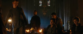 Movie still from “Maze Runner: The Death Cure” (2018), directed by Wes Ball – A group of people standing around a table with candles; Medium shot, Low angle