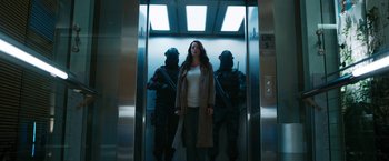 Movie still from “Maze Runner: The Death Cure” (2018), directed by Wes Ball – A woman standing in an elevator between two armed men; Wide shot, Low angle