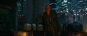 Movie still from “Maze Runner: The Death Cure” (2018), directed by Wes Ball – A man standing in the dark with a bag of luggage behind him; Medium shot, Low angle