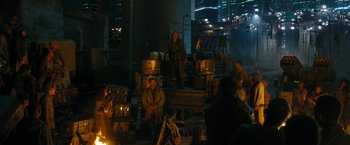 Movie still from “Maze Runner: The Death Cure” (2018), directed by Wes Ball – A group of people sitting around a fire pit; Wide shot, Over the shoulder angle
