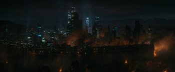 Movie still from “Maze Runner: The Death Cure” (2018), directed by Wes Ball – A city lit up at night with smoke coming out of it; Extreme Wide shot, High angle