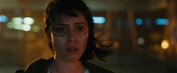 Movie still from “Maze Runner: The Death Cure” (2018), directed by Wes Ball – A young woman looking at the camera in a dimly - lit room; Close Up shot, Low angle