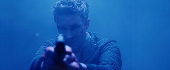 Movie still from “Maze Runner: The Death Cure” (2018), directed by Wes Ball – A man is holding a gun in the water; Close Up shot, Low angle