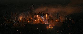 Movie still from “Maze Runner: The Death Cure” (2018), directed by Wes Ball – An airplane is flying over a burning city; Extreme Wide shot, High angle