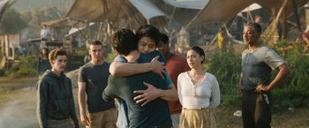 Movie still from “Maze Runner: The Death Cure” (2018), directed by Wes Ball – A group of young people hugging each other in front of a crowd; Medium shot, Over the shoulder angle
