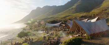 Movie still from “Maze Runner: The Death Cure” (2018), directed by Wes Ball – A group of people standing around a field with tents; Extreme Wide shot, High angle