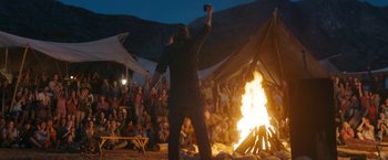 Movie still from “Maze Runner: The Death Cure” (2018), directed by Wes Ball – A crowd of people sitting around a campfire; Wide shot, Over the shoulder angle