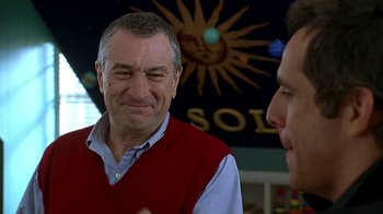 Movie still from “Meet the Fockers” (2004), directed by Jay Roach – A man in a red vest is talking to another man in a blue shirt; Close Up shot, Over the shoulder angle