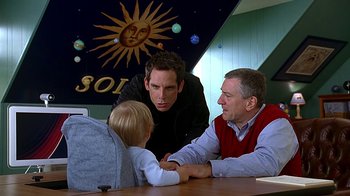 Movie still from “Meet the Fockers” (2004), directed by Jay Roach – Two men and a boy sitting at a table; Medium shot, Over the shoulder angle