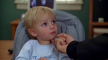 Movie still from “Meet the Fockers” (2004), directed by Jay Roach – A young child being held up by a person; Close Up shot, Over the shoulder angle