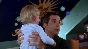 Movie still from “Meet the Fockers” (2004), directed by Jay Roach – A man holding a child in his arms; Close Up shot, Over the shoulder angle