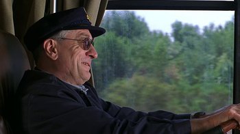 Movie still from “Meet the Fockers” (2004), directed by Jay Roach – An older man wearing a hat driving a train; Medium shot, Low angle