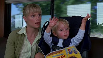 Movie still from “Meet the Fockers” (2004), directed by Jay Roach – A woman and a child sitting in a car seat; Medium shot, Low angle