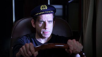 Movie still from “Meet the Fockers” (2004), directed by Jay Roach – A man wearing a sailor's hat while sitting in a chair; Close Up shot, Over the shoulder angle