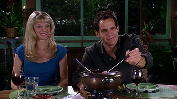 Movie still from “Meet the Fockers” (2004), directed by Jay Roach – A man and a woman sitting in front of a bowl of food; Medium shot, Over the shoulder angle
