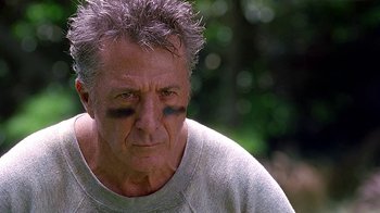 Movie still from “Meet the Fockers” (2004), directed by Jay Roach – An older man with a bruised eye and a bruise on his face; Close Up shot, Over the shoulder angle