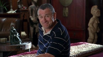 Movie still from “Meet the Fockers” (2004), directed by Jay Roach – An older man sitting at a table in front of a mirror; Medium shot, Over the shoulder angle