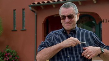 Movie still from “Meet the Fockers” (2004), directed by Jay Roach – An older man wearing sunglasses and holding a fork; Close Up shot, Low angle