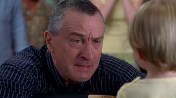 Movie still from “Meet the Fockers” (2004), directed by Jay Roach – An older man sitting at a table with a young child; Close Up shot, Over the shoulder angle