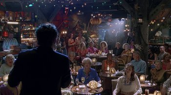 Movie still from “Meet the Fockers” (2004), directed by Jay Roach – A group of people sitting at tables in a room; Wide shot, Over the shoulder angle