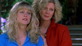 Movie still from “Meet the Fockers” (2004), directed by Jay Roach – Two women posing for a picture in front of a tree; Close Up shot, Low angle
