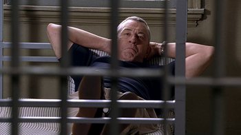 Movie still from “Meet the Fockers” (2004), directed by Jay Roach – A man laying on a bed in front of a window; Medium shot, Low angle