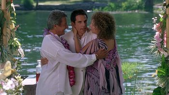 Movie still from “Meet the Fockers” (2004), directed by Jay Roach – A man and two women embracing each other near a body of water; Medium shot, High angle