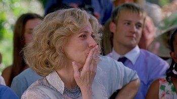 Movie still from “Meet the Fockers” (2004), directed by Jay Roach – A woman with her hands over her mouth; Close Up shot, Over the shoulder angle