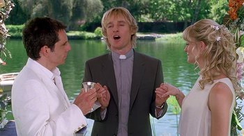 Movie still from “Meet the Fockers” (2004), directed by Jay Roach – Two men and a woman standing in front of a body of water; Medium shot, Over the shoulder angle