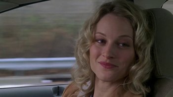 Movie still from “Meet the Parents” (2000), directed by Jay Roach – A woman sitting in the back seat of a car; Close Up shot, Over the shoulder angle