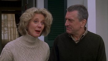 Movie still from “Meet the Parents” (2000), directed by Jay Roach – An older man and a younger woman standing next to each other; Close Up shot, Low angle