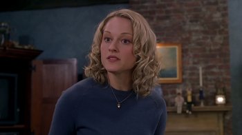 Movie still from “Meet the Parents” (2000), directed by Jay Roach – A woman with blonde curly hair wearing a blue sweater; Close Up shot, Over the shoulder angle