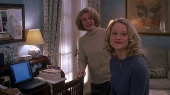 Movie still from “Meet the Parents” (2000), directed by Jay Roach – Two women standing next to each other in front of a table; Medium shot, High angle