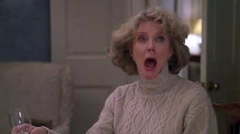 Movie still from “Meet the Parents” (2000), directed by Jay Roach – An older woman with blonde curly hair is looking surprised with her mouth open; Close Up shot, Low angle