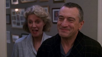 Movie still from “Meet the Parents” (2000), directed by Jay Roach – A man and a woman smiling for the camera; Close Up shot, Low angle