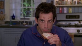 Movie still from “Meet the Parents” (2000), directed by Jay Roach – A person holding a piece of bread; Close Up shot, High angle